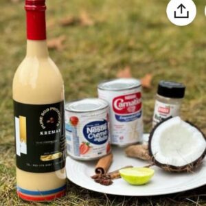 A bottle of wine and cans on the ground