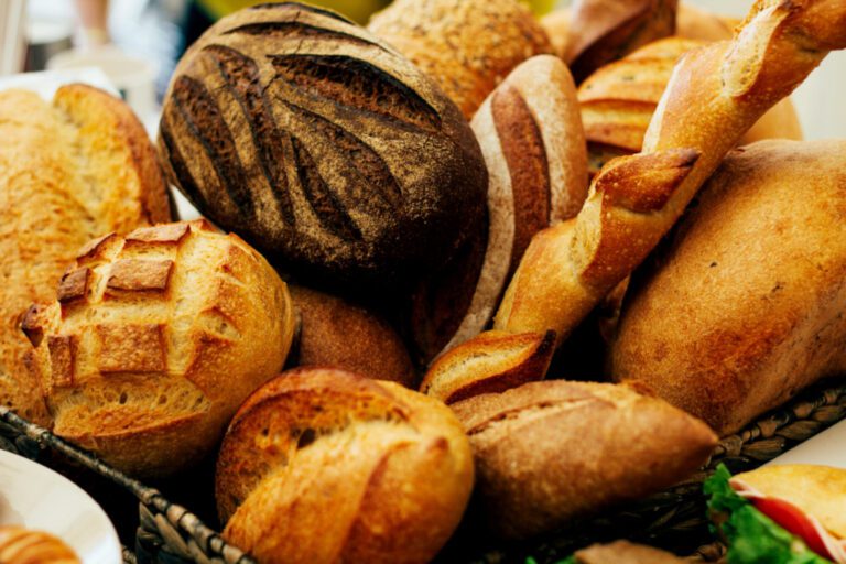 A basket of bread is full of different types.