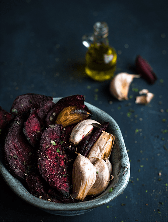 A bowl of food with mushrooms and beets.